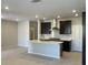 Open concept kitchen with a kitchen island, stainless steel appliances, and dark cabinetry at 11414 Ethereal Landing Ave, Las Vegas, NV 89138