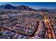 Stunning aerial view of a Primary-planned community against a backdrop of majestic mountains at dusk at 11831 Saverio Ave, Las Vegas, NV 89138