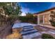 Backyard brick patio with stone steps and surrounding greenery at 11831 Saverio Ave, Las Vegas, NV 89138