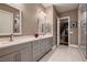 Bathroom featuring dual sinks, modern fixtures, and a glass-enclosed shower at 11831 Saverio Ave, Las Vegas, NV 89138