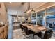 Open-concept dining room with hardwood floors, modern lighting, and access to the backyard at 11831 Saverio Ave, Las Vegas, NV 89138