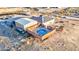 Aerial view of rural desert home with in-ground pool, storage barn and play structure at 1464 Barlow Ave, Moapa, NV 89025