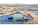 Aerial view of desert home featuring a barn, pool and distant mountain range at 1464 Barlow Ave, Moapa, NV 89025