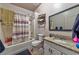 Full bathroom with a tub-shower combo, granite vanity and grey tile at 1464 Barlow Ave, Moapa, NV 89025