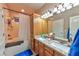 Bathroom featuring double sinks, granite countertops, and a shower-tub combo at 1464 Barlow Ave, Moapa, NV 89025