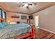 Comfortable bedroom with a rustic wooden bed frame, wood floors, and plenty of natural light from the window at 1464 Barlow Ave, Moapa, NV 89025