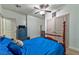 Bedroom featuring a four poster bed, blue accent wall, and wood-look flooring at 1464 Barlow Ave, Moapa, NV 89025