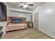 Bright bedroom with wood-look flooring, ceiling fan, and bunk beds at 1464 Barlow Ave, Moapa, NV 89025