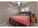 Bedroom featuring a dark wood frame bed, ceiling fan, and window with shutter blinds at 1464 Barlow Ave, Moapa, NV 89025