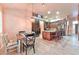 Charming dining area with a rustic table setting and view into the open kitchen with counter seating at 1464 Barlow Ave, Moapa, NV 89025