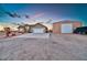 Single-story home with 2-car garage, xeriscaping and additional storage outbuilding at 1464 Barlow Ave, Moapa, NV 89025