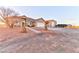 View of the home with a two-car garage and a separate storage building at 1464 Barlow Ave, Moapa, NV 89025