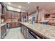 Chef's kitchen featuring a huge island with a granite countertop and wooden cabinetry at 1464 Barlow Ave, Moapa, NV 89025