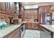 Close-up of kitchen featuring granite counters, tile backsplash, stainless steel appliances, and dark cabinets at 1464 Barlow Ave, Moapa, NV 89025