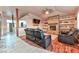 A cozy living room with brick fireplace, tv, ceiling fan and comfortable, reclining leather sofas at 1464 Barlow Ave, Moapa, NV 89025