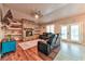 Comfortable living room showcasing a brick fireplace, built-in shelves, and plush leather seating at 1464 Barlow Ave, Moapa, NV 89025