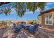 Backyard seating area with mature trees, brick patio, and lush landscaping at 1564 Fieldbrook St, Henderson, NV 89052