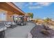 Backyard patio with comfortable seating, a grill, and lush landscaping, perfect for outdoor entertaining at 1564 Fieldbrook St, Henderson, NV 89052