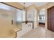 Relaxing bathroom featuring a soaking tub with a decorative chandelier and a separate glass-enclosed shower at 1564 Fieldbrook St, Henderson, NV 89052