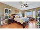 Comfortable bedroom with a ceiling fan, natural light from a large window, and a cozy seating area at 1564 Fieldbrook St, Henderson, NV 89052