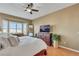 Bedroom with a corner view of the window, dresser, and a large screen TV, enhanced with natural lighting at 1564 Fieldbrook St, Henderson, NV 89052