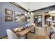 Chic dining room featuring a rustic wood table, modern lighting, and elegant decor with open access to other living spaces at 1564 Fieldbrook St, Henderson, NV 89052