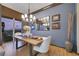 Stylish dining area with natural light, a modern chandelier, and open access to an outdoor seating area at 1564 Fieldbrook St, Henderson, NV 89052