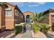 Elegant home entrance with a decorative gate, manicured landscaping, and a warm, inviting feel at 1564 Fieldbrook St, Henderson, NV 89052