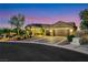 Elegant single-story home showcasing a two-car garage, lush tropical landscaping, and a well-maintained driveway at 1564 Fieldbrook St, Henderson, NV 89052