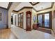 Inviting foyer showcasing neutral walls, tile and wood floors, and views of the entry with decorative glass doors at 1564 Fieldbrook St, Henderson, NV 89052