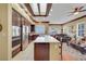 Open kitchen with island gas cooktop, stainless steel appliances, and adjacent living room at 1564 Fieldbrook St, Henderson, NV 89052