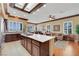 Bright kitchen featuring a large island with cooktop, skylight, and tile and wood flooring at 1564 Fieldbrook St, Henderson, NV 89052