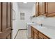 Well-equipped laundry room features modern washer and dryer, storage cabinets, and a sink at 1564 Fieldbrook St, Henderson, NV 89052