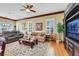 Comfortable living room featuring hardwood floors, bright windows, and a stylish coffee table at 1564 Fieldbrook St, Henderson, NV 89052