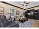 Comfortable living room with a ceiling fan, a media center, and lots of natural light at 1564 Fieldbrook St, Henderson, NV 89052