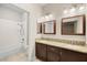 Well-lit bathroom featuring double sinks, granite countertops, and a shower-tub combination at 1851 Hillpointe Rd # 2922, Henderson, NV 89074