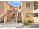 Stucco building exterior with stairs leading to upper-level units and desert landscaping at 1851 Hillpointe Rd # 2922, Henderson, NV 89074