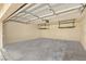 Clean, empty garage with overhead storage racks and sealed concrete flooring is ready to be filled at 1851 Hillpointe Rd # 2922, Henderson, NV 89074