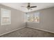 This bedroom features neutral paint, carpet, a ceiling fan, and window shutters at 2153 Havensight Ln, Henderson, NV 89052