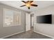 Bedroom with neutral walls, carpet, window shutters, and a flat screen television at 2153 Havensight Ln, Henderson, NV 89052