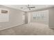 Spacious bedroom featuring a ceiling fan, neutral carpeting, and multiple windows with bright natural light at 2153 Havensight Ln, Henderson, NV 89052