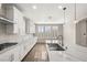 Bright kitchen with white cabinets, stainless steel sink, and marble countertops at 2153 Havensight Ln, Henderson, NV 89052