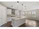 Modern kitchen with sleek white cabinets, stainless steel hood, and center island at 2153 Havensight Ln, Henderson, NV 89052