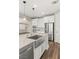 Kitchen view highlighting a stainless steel farmhouse sink, modern appliances, and hardwood flooring at 2153 Havensight Ln, Henderson, NV 89052