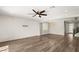 Open-concept living room with ceiling fan, luxury floors, and lots of light coming through the windows at 2153 Havensight Ln, Henderson, NV 89052