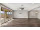 Open-concept living room features a ceiling fan, wood floors and sliding doors to the backyard at 2153 Havensight Ln, Henderson, NV 89052