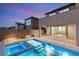 Stunning pool and spa with modern lighting, set against the backdrop of a contemporary home at twilight at 2153 Havensight Ln, Henderson, NV 89052