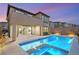 Exterior view of the backyard, featuring a pool, spa, and patio at 2153 Havensight Ln, Henderson, NV 89052