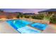 View of the backyard featuring a custom pool with elevated spa and patio at 2153 Havensight Ln, Henderson, NV 89052