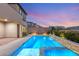 Backyard view featuring a custom pool with elevated spa and brick retaining wall at 2153 Havensight Ln, Henderson, NV 89052